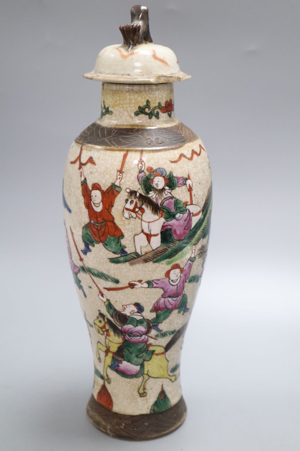 A Chinese famille rose crackleglaze vase and cover, together with a Chinese blue and white figural vase bearing Kangxi mark,